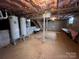 Large unfinished basement with stairs, water heaters, and block foundation at 920 Oakridge Farm Hwy, Mooresville, NC 28115