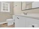 Neutral bathroom features a white single sink vanity, framed mirror and natural lighting at 920 Oakridge Farm Hwy, Mooresville, NC 28115