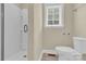 Clean bathroom with shower stall, toilet, and window providing natural light at 920 Oakridge Farm Hwy, Mooresville, NC 28115
