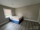 Cozy bedroom with hardwood floors and a window letting in natural light at 920 Oakridge Farm Hwy, Mooresville, NC 28115