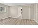 A bedroom featuring neutral colors, light-colored laminate floors, a window and a large closet at 920 Oakridge Farm Hwy, Mooresville, NC 28115
