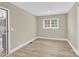 Bedroom featuring neutral colors, light-colored laminate floors, a window and white trim at 920 Oakridge Farm Hwy, Mooresville, NC 28115