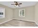 Bedroom with ceiling fan, two windows and neutral paint at 920 Oakridge Farm Hwy, Mooresville, NC 28115
