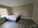 Well-lit bedroom featuring hardwood floors, bright light, and neutral wall colors at 920 Oakridge Farm Hwy, Mooresville, NC 28115