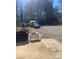 Large, partially paved driveway leading to outbuildings and woods at 920 Oakridge Farm Hwy, Mooresville, NC 28115