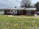 Charming single-story home with a metal roof, covered porch, and a well-maintained lawn at 920 Oakridge Farm Hwy, Mooresville, NC 28115