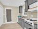 Well-lit kitchen featuring grey cabinets, granite countertops, and stainless steel appliances at 920 Oakridge Farm Hwy, Mooresville, NC 28115