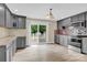 Spacious kitchen featuring grey cabinets, granite countertops, and access to a patio at 920 Oakridge Farm Hwy, Mooresville, NC 28115