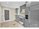 Charming kitchen with grey cabinets, modern appliances, and a door to the outside at 920 Oakridge Farm Hwy, Mooresville, NC 28115