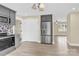 Bright kitchen featuring stainless steel refrigerator, gray cabinets, and adjacent dining area at 920 Oakridge Farm Hwy, Mooresville, NC 28115