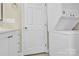 Bathroom laundry area featuring a stacked washer/dryer unit and white cabinets at 920 Oakridge Farm Hwy, Mooresville, NC 28115