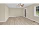 Bright, airy living room features new floors, fresh paint, a ceiling fan and a large window with lots of light at 920 Oakridge Farm Hwy, Mooresville, NC 28115
