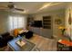 Bright living room featuring a ceiling fan, a large TV, and updated flooring at 920 Oakridge Farm Hwy, Mooresville, NC 28115