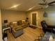 Comfortable living room featuring hardwood floors, a ceiling fan, and neutral paint at 920 Oakridge Farm Hwy, Mooresville, NC 28115