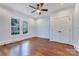 This bedroom features hardwood floors, natural light, and a ceiling fan at 1006 N Ridge Ave, Kannapolis, NC 28083