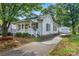 Inviting home showcasing a driveway, mature trees, and a detached garage at 1006 N Ridge Ave, Kannapolis, NC 28083