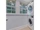 Laundry area features natural lighting and a stacked washer and dryer at 1006 N Ridge Ave, Kannapolis, NC 28083