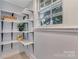 Bright pantry features built-in shelving and natural lighting at 1006 N Ridge Ave, Kannapolis, NC 28083