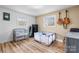 Multi-purpose bedroom with wood-look flooring, two windows, and neutral color scheme at 104 Pop Davis Rd, Taylorsville, NC 28681
