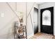 Stylish foyer featuring decorative wall trim, wood floors, and a charming front door at 104 Pop Davis Rd, Taylorsville, NC 28681