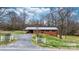 Well-kept brick house featuring a metal roof, level lot and mature trees creating a serene outdoor space at 104 Pop Davis Rd, Taylorsville, NC 28681