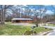 Charming single-story brick home with a metal roof, a well-maintained yard, and a white picket fence at 104 Pop Davis Rd, Taylorsville, NC 28681