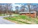 Quaint brick home with a metal roof, covered carport, and a spacious front yard at 104 Pop Davis Rd, Taylorsville, NC 28681