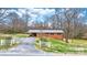 Inviting brick home with a metal roof, carport, white picket fence, and a well-manicured lawn at 104 Pop Davis Rd, Taylorsville, NC 28681