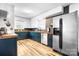 Spacious kitchen featuring updated stainless steel appliances, painted cabinets, and stylish hardwood floors at 104 Pop Davis Rd, Taylorsville, NC 28681