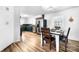 Bright kitchen and dining area with stainless steel appliances, painted cabinets, and stylish hardwood floors at 104 Pop Davis Rd, Taylorsville, NC 28681