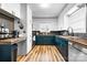 Bright and modern kitchen featuring updated appliances, painted cabinets, and stylish wood floors at 104 Pop Davis Rd, Taylorsville, NC 28681
