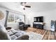 Bright living room with hardwood floors, a cozy sofa, and large windows offering natural light at 104 Pop Davis Rd, Taylorsville, NC 28681