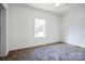 Clean, well-lit bedroom with carpeting and a window offering natural light at 108 Sarah Ave, Newton, NC 28658