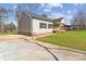 View of the home with a concrete driveway, spacious lawn, and charming front porch at 108 Sarah Ave, Newton, NC 28658