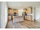 Well-lit kitchen featuring light wood cabinets, stainless steel appliances, and a convenient center island at 108 Sarah Ave, Newton, NC 28658