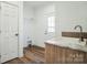 Functional laundry room with sink, shelving, and door to outside at 108 Sarah Ave, Newton, NC 28658