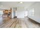 Bright living area with hardwood floors seamlessly connecting to an open-concept kitchen at 108 Sarah Ave, Newton, NC 28658