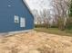 Side view of a home with blue siding and two windows, surrounded by bare yard and trees at 1137 Williams St, Rock Hill, SC 29732