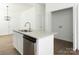 Bright kitchen island featuring granite countertops, stainless dishwasher, and sleek cabinets at 1137 Williams St, Rock Hill, SC 29732