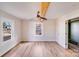 Bright bedroom featuring hardwood floors, ceiling fan, wood beam, and closet at 1200 Grace Ave, Kannapolis, NC 28083