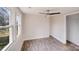 Sunny bedroom showcasing vinyl flooring and large windows offering backyard views at 1200 Grace Ave, Kannapolis, NC 28083