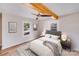 Bright bedroom featuring hardwood floors, ceiling fan, and decorative wood beam at 1200 Grace Ave, Kannapolis, NC 28083