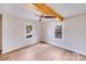 Bright bedroom featuring hardwood floors, ceiling fan, and decorative wood beam at 1200 Grace Ave, Kannapolis, NC 28083