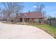 Beautifully landscaped home with a spacious driveway and a black wooden fence, providing privacy at 1200 Grace Ave, Kannapolis, NC 28083