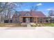 Charming home featuring dark gray siding, a brown roof, an inviting front entry and tidy landscaping at 1200 Grace Ave, Kannapolis, NC 28083