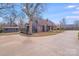 Quaint two-story home with a long driveway, complimented by mature trees at 1200 Grace Ave, Kannapolis, NC 28083