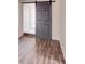 Inviting living room featuring a barn door and hardwood floors, seamlessly blending style and functionality at 1200 Grace Ave, Kannapolis, NC 28083