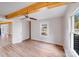 Open-concept room featuring hardwood floors, wood beam, and view to the front yard at 1200 Grace Ave, Kannapolis, NC 28083