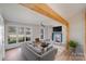 Bright living room featuring a fireplace, ceiling fan, and large windows that fill the space with natural light at 1200 Grace Ave, Kannapolis, NC 28083