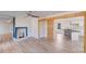 Open-concept living room with hardwood floors, decorative wood beam, and fireplace at 1200 Grace Ave, Kannapolis, NC 28083